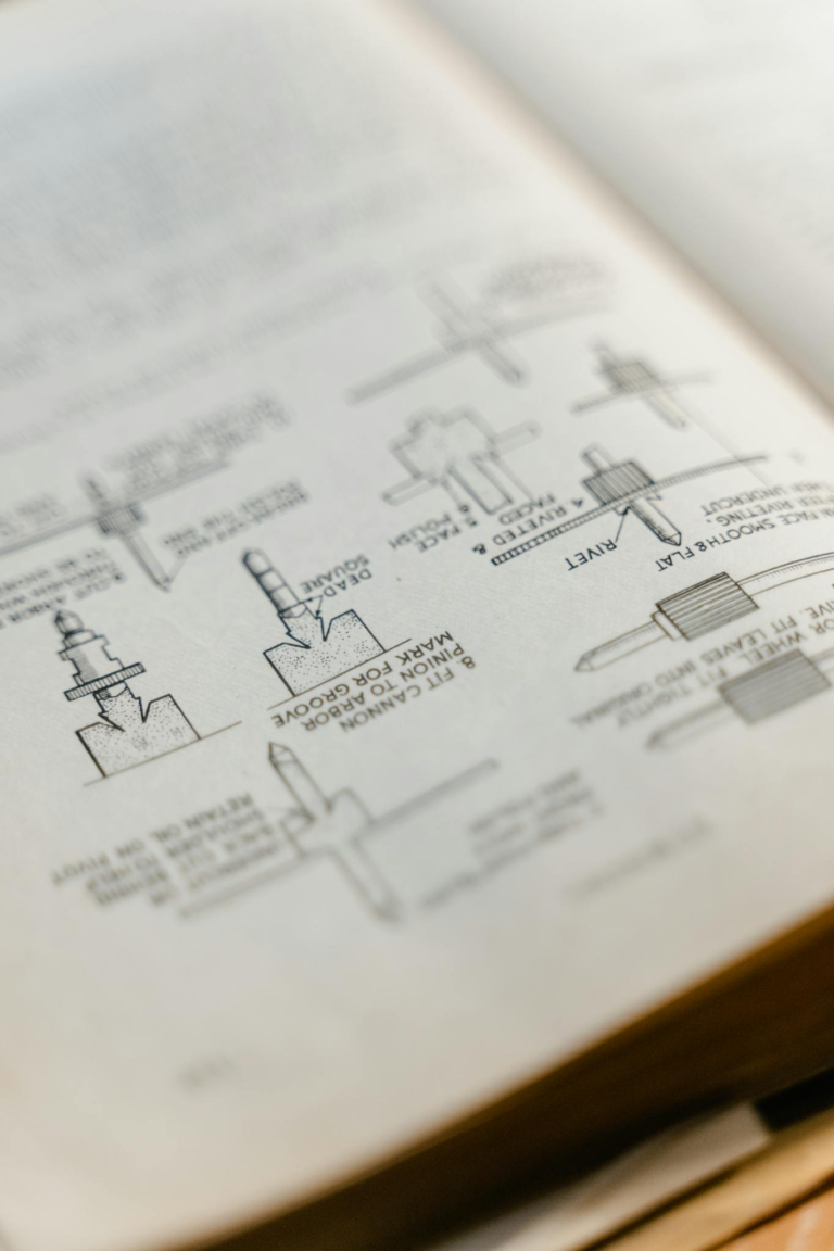 Close-up of an open book featuring detailed technical diagrams and sketches.
